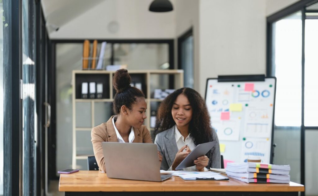 Two-young-business-people-working-together-in-office-financial-analysis-accounting-concept-.jpg